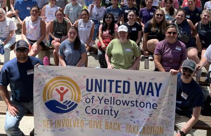 A group of people hold a banner at Day of Action